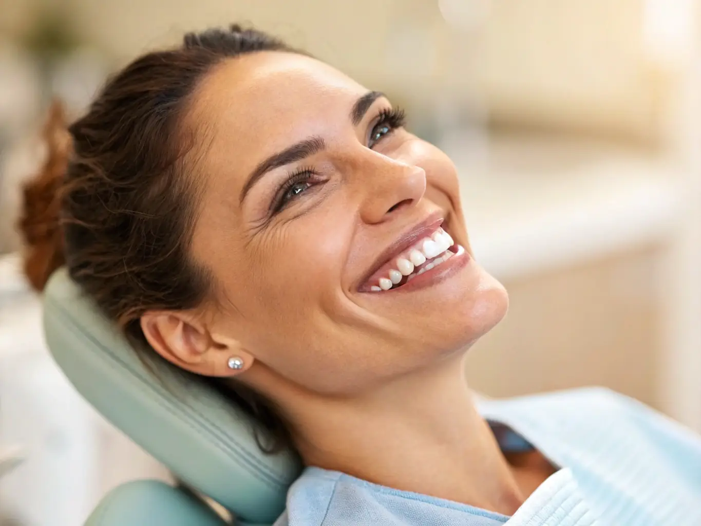 A close-up image of a patient smiling with beautiful, natural-looking veneers, showcasing the transformative results achieved at LetsDentalSmile.